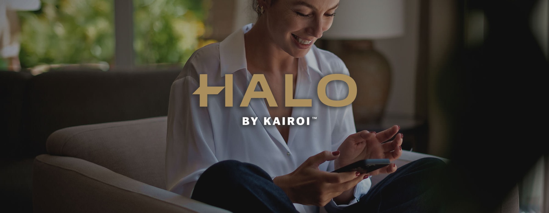 a woman smiling and interacting with her device