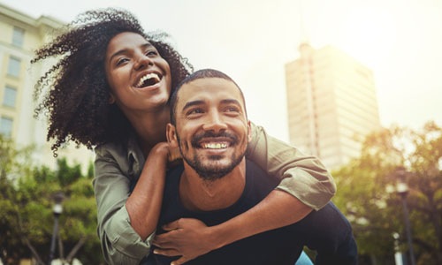 a couple laughing outdoors